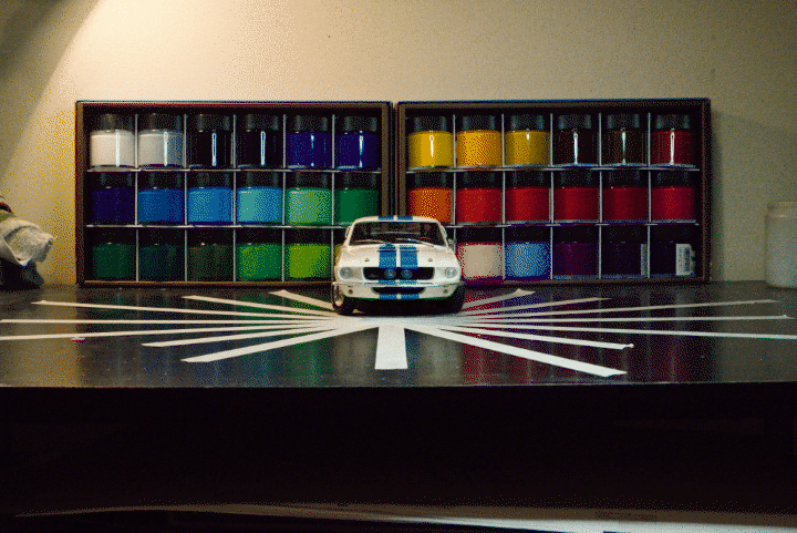A looping gif image of a model car spinning in circles.